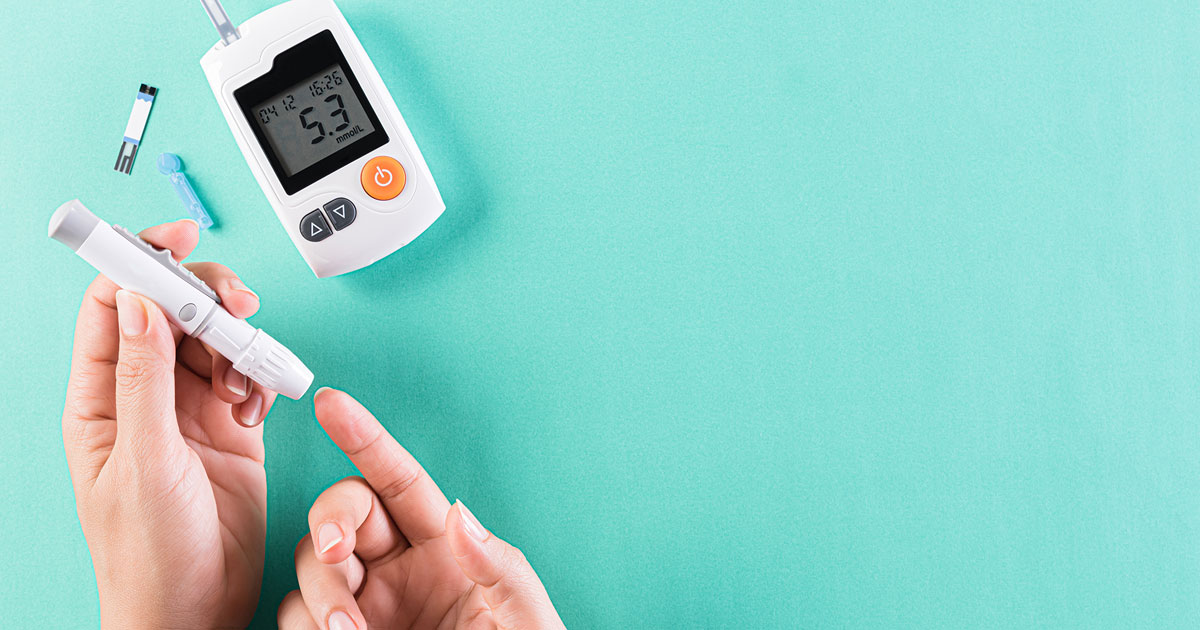 Close-up of a woman completing blood sugar test for diabetes.