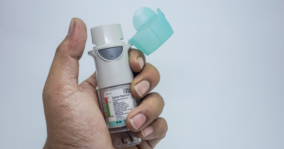 Man holding respimat inhaler