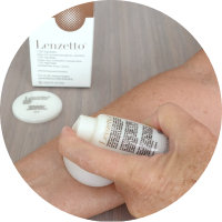Woman using Lenzetto spray on forearm.