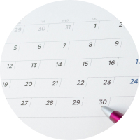 A close-up of a calendar featuring a red pen.