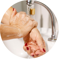 A close-up of a woman washing her hands