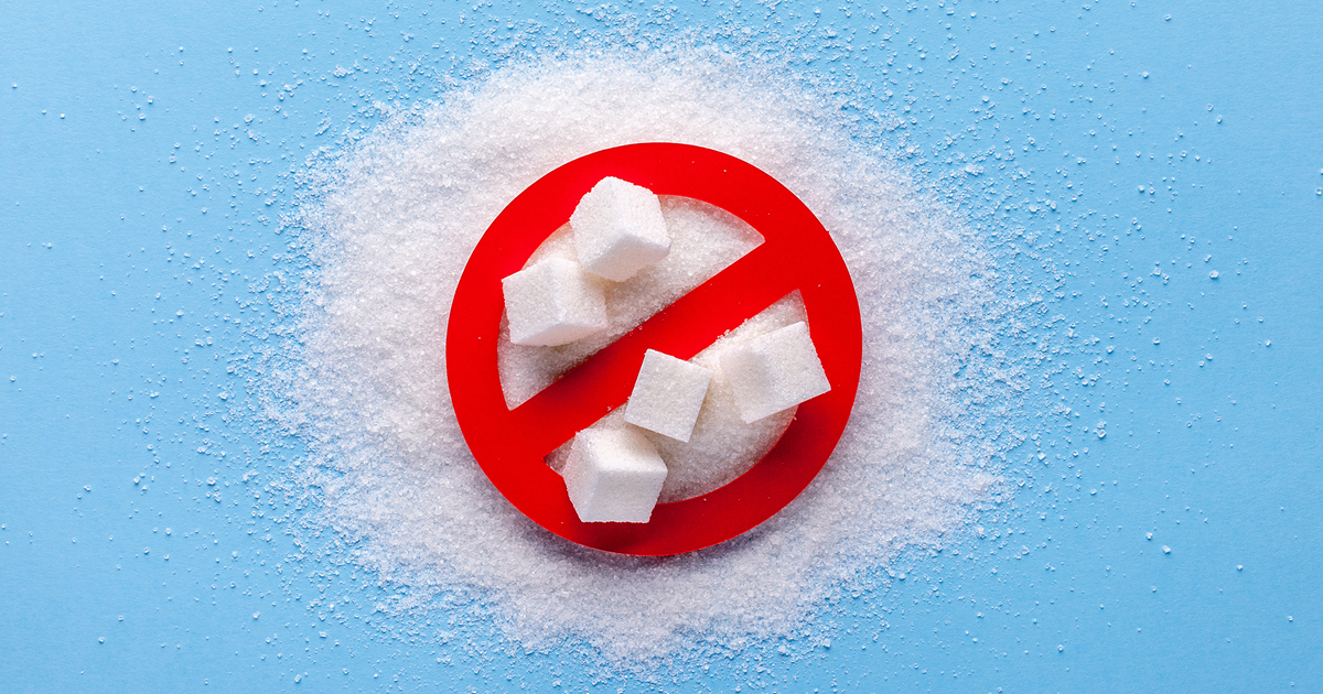 A prohibition sign next to a pile of white sugar