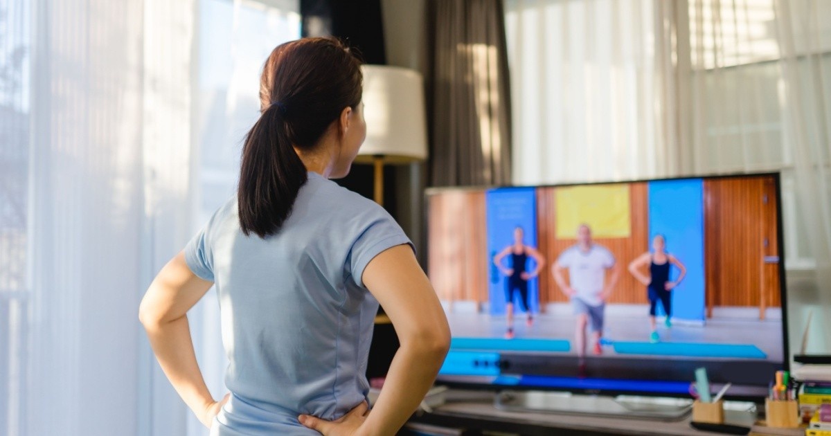 Woman working out at home fitness video.