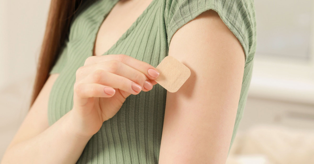 Image of a woman applying her contraceptive patch