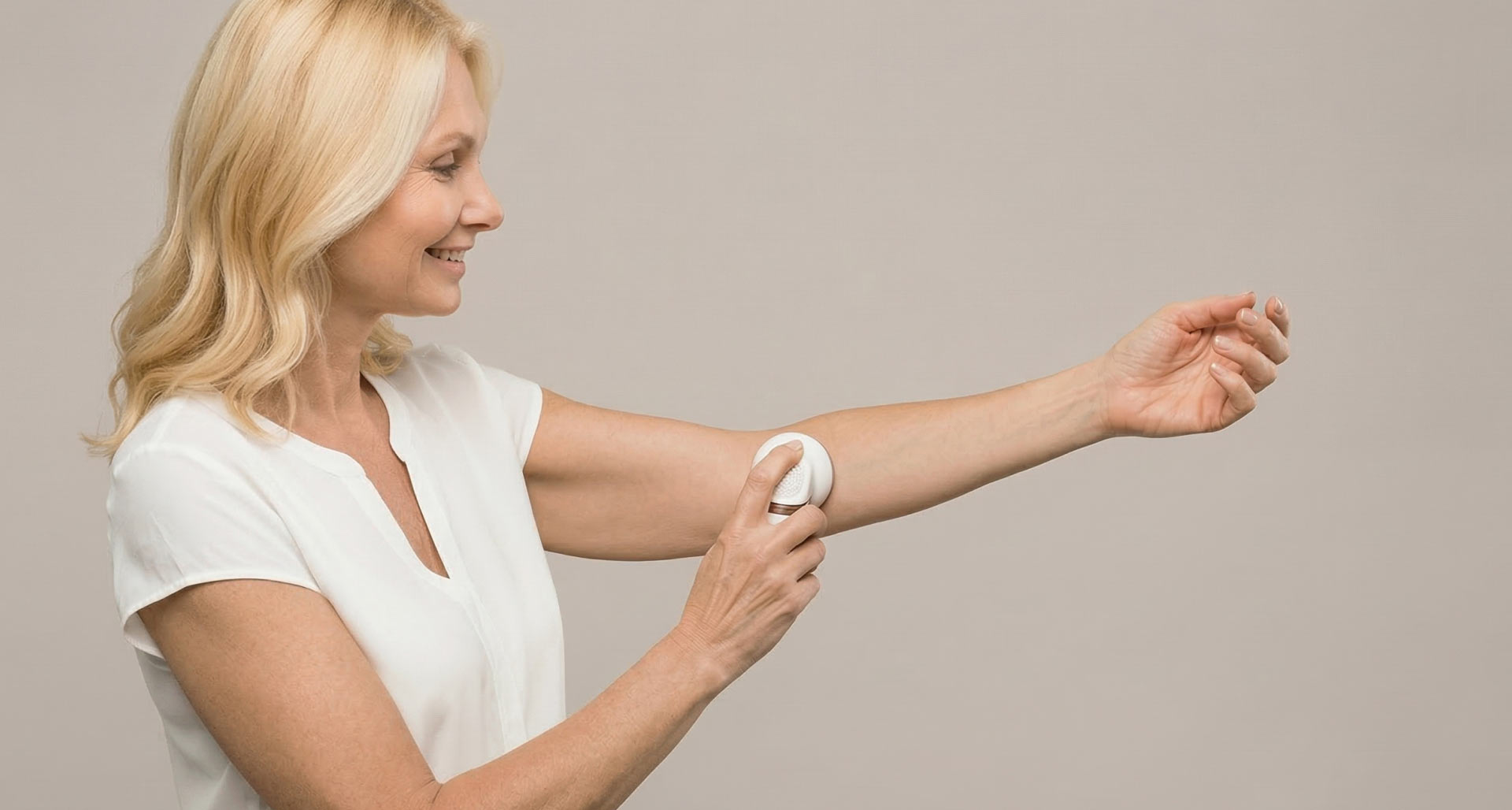 Woman using a spray on her forearm.