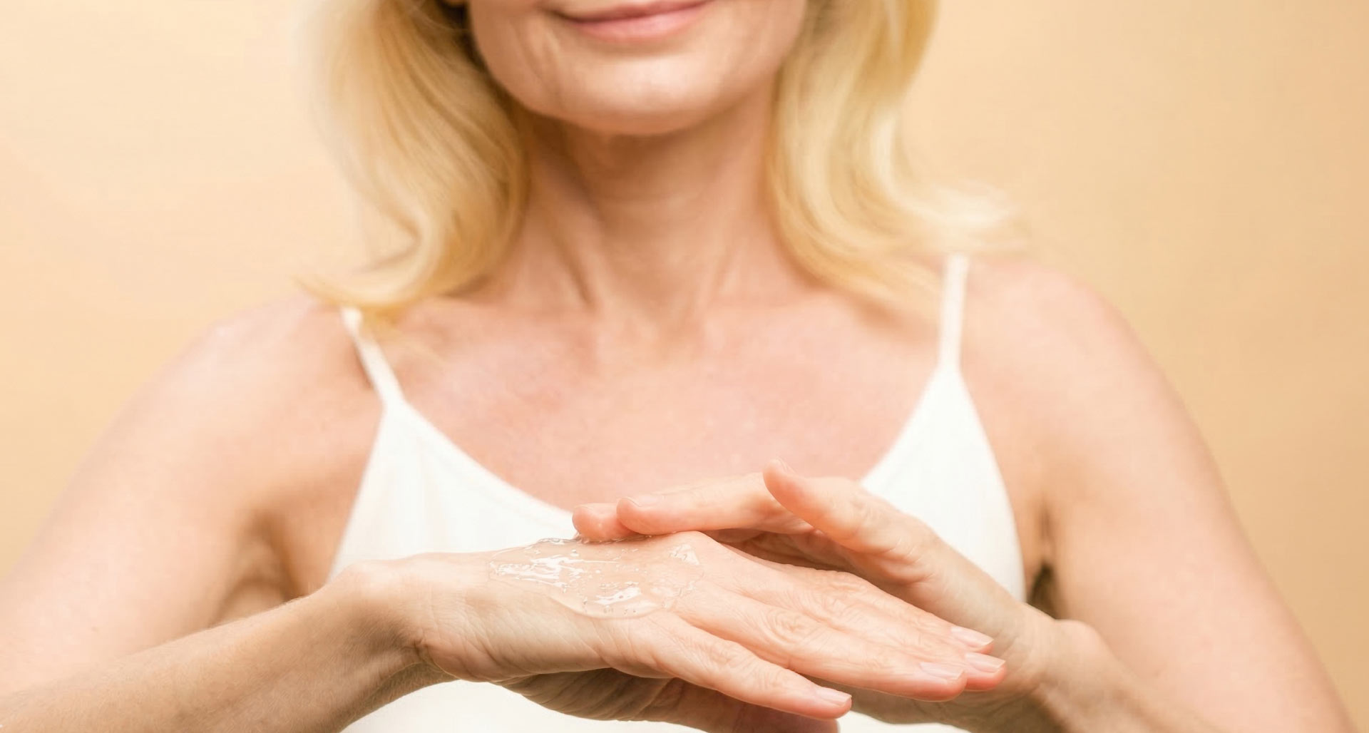 A woman applying a gel into her hands.
