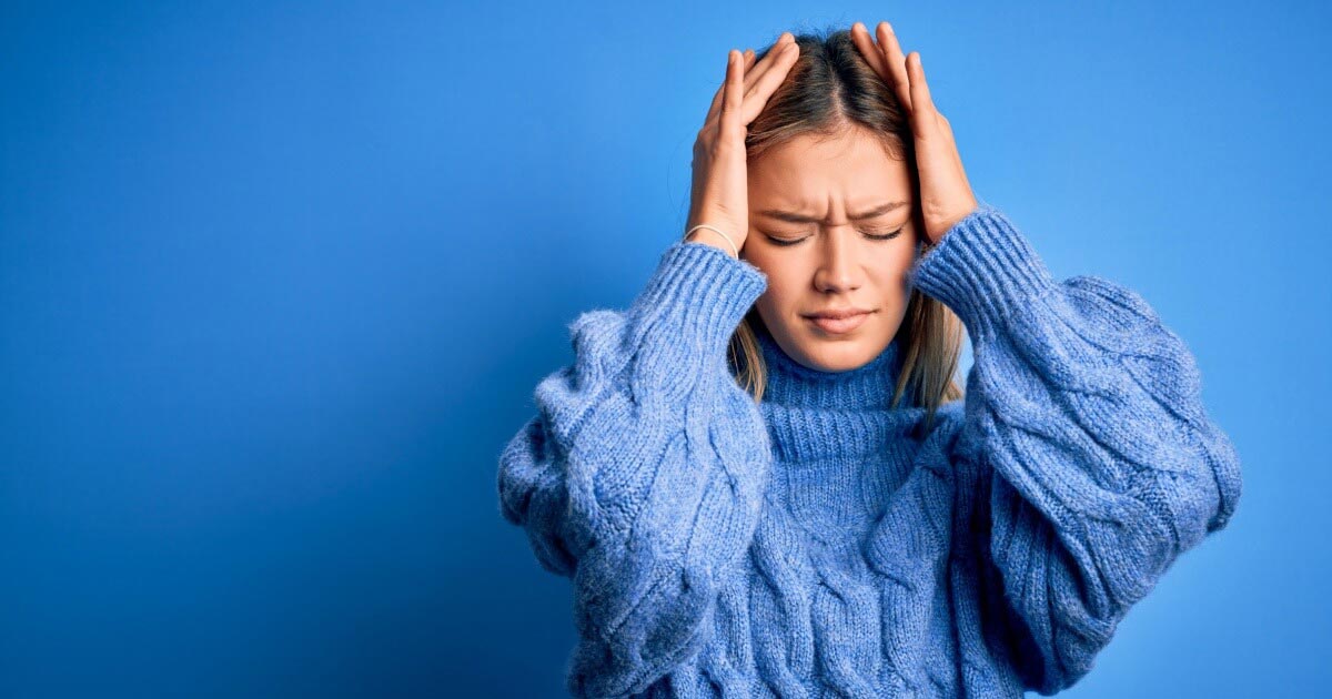 A woman suffering from a painful headache. 